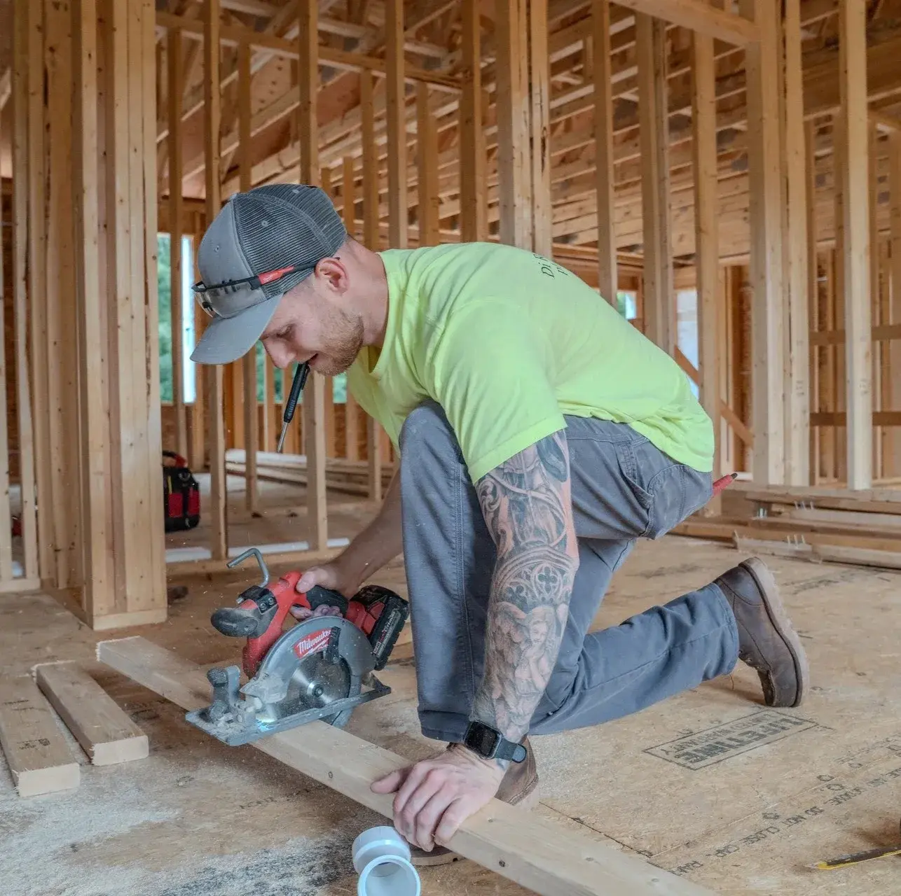 Zach DiRenzi cutting a piece of wood with a saw