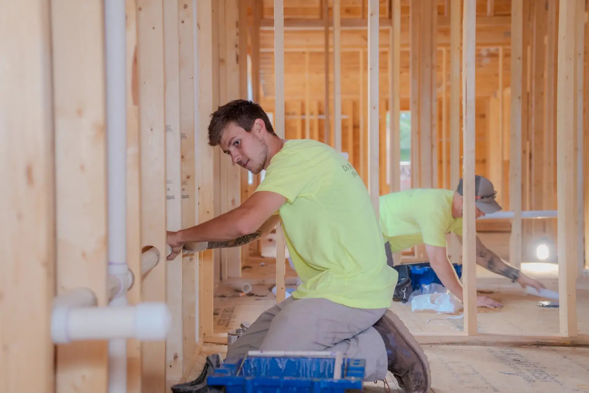 Colin placing a pipe in a new home frame